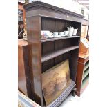 A 1920s mahogany open bookcase, 106cm wide, (two shelves warped).