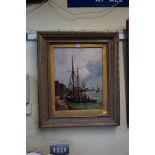 R Nibbs, a sailing barge by a Dutch dockside, signed, oil on canvas, 44.5 x 34.5cm.