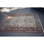 A Persian rug, having urn and allover floral decoration to central field, with floral and