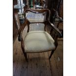 A mid 19th century rosewood elbow chair, on reeded legs to the front.