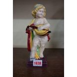 An early 20th century Weiner Werkstatte pottery figure of a cherub, impressed marks