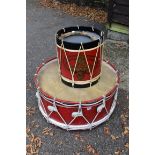 A large red painted drum, 73cm wide x 36cm high; together with a smaller example.This lot can only