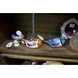 A Royal Copenhagen robin; together with three Royal Crown Derby Imari bird paperweights.