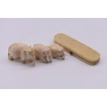 A Georgian ivory toothpick case, 8.5cm wide; together with three small carved ivory elephants.