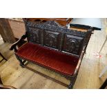 A 19th century carved oak settle, with panel back, 124cm wide.