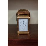 A good antique gilt brass carriage clock, striking on a gong with alarm and push button repeat,