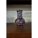 A Chinese famille rose yixing bottle vase, 19th century, 16.5cm high, (shallow chip to rim),