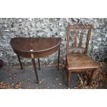 An old demi-lune foldover card table; together with a carved oak chair. This lot can only be