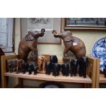 A collection of ebony and other hard wood elephants, largest 40cm high.