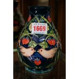 A Moorcroft 'Strawberry Thief' pattern baluster vase, 13.5cm high.