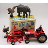 A Marx battery operated farm tractor, boxed; together with three Elastolin animals.