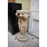 An old composition stone pedestal, with cherub support, 65cm high.