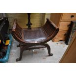 A late Victorian carved oak 'X' framed stool.