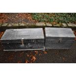 Two old black painted trunks, largest 85.5cm wide.This lot can only be collected on Saturday 10th