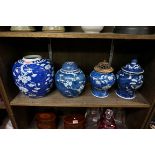 Three Chinese blue and white prunus jars and three covers, largest 21cm high.