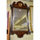 An 18th century mahogany and parcel gilt fret framed wall mirror, 77.5 x 44.5cm.