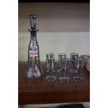 A Continental silver overlaid clear glass liqueur set, the decanter and stopper 24cm high.