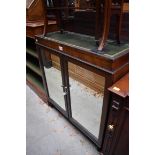 A mahogany side cabinet, with a pair of mirrored panelled doors, 81cm wide.