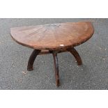 An old table, made from a cartwheel, 110cm wide x 75cm high.This lot can only be collected on