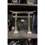 An early 20th century Japanese brass table gong, 32cm high.