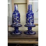 A pair of antique Bohemian blue overlaid glass vases, relief moulded with scrolling foliage and with