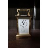 A Charles Frodsham brass carriage timepiece, height including handle 15.5cm, with winding key.