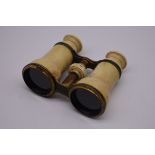 A pair of ivory and gilt brass opera glasses, by F L West, (split to one eye piece).
