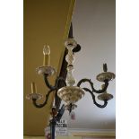 A brass and ceramic five branch ceiling light.