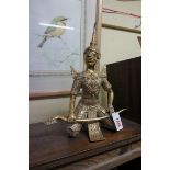 A Thai brass kneeling figure, 35cm high.