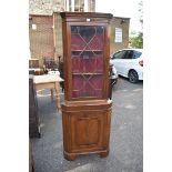 A reproduction mahogany standing corner cupboard. This lot can only be collected on Saturday 10th