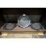 A set of three Arts & Crafts embossed copper plates, 23cm diameter.
