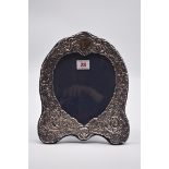 An embossed silver easel back photograph frame, by D R & S, London 1986, 26cm high.