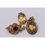 A garnet set stylised leaf gold pendant, hallmarked 375, 6g; together with an oval citrine gold