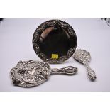 An Art Nouveau silver hand mirror by Levi & Salaman, Birmingham 1903; together with matching