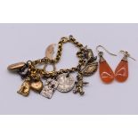 A pair of carnelian yellow metal drop earrings; together with a charm bracelet, one charm stamped