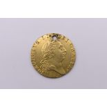 Coins: a George III 1788 gold spade guinea, drilled.