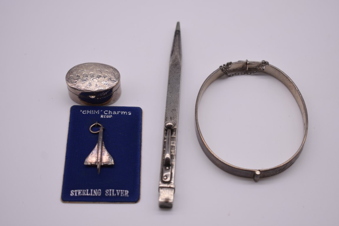 Four silver and other metal items, to include a silver hinged bangle, a propelling pencil etc.