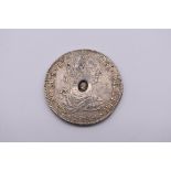 Coins: a George III 1789 silver dollar, having oval countermark, 27g.