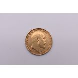 Coins: an Edward VII 1904 gold half sovereign.