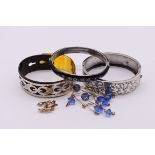 Three silver and white metal bangles; together with two other items of jewellery. (5)