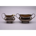 A George III silver twin handled sugar basin, by J.A, London 1799, 9.5cm high; together with a