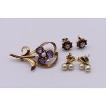 An amethyst and pearl floral brooch, stamped 9ct, 5.6g; together with two pairs of yellow metal