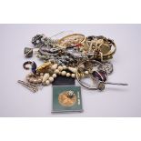 A quantity of costume jewellery, to include brooches, bangles and beads.