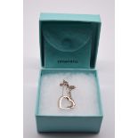 A Tiffany & Co silver open heart pendant and chain, by Elsa Peretti, each marked, with suede