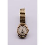 A vintage Smiths 'Deluxe' 9ct gold manual wind wristwatch, on later plated expanding bracelet.