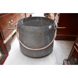 A large copper cauldron, with swing handle, 39cm diameter.