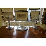 A pair of electroplated twin branch candelabra, 40cm high; together with another electroplated