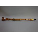 An early 19th century boxwood clarinet, by G Astor & Co, with five brass 'spade' keys, 65.5cm long.