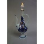 An Islamic opaque glass ewer, with blue and gilt floral decoration, 25cm high; with associated