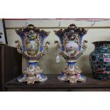 A large pair of Victorian Grainger & Co Worcester twin handled pedestal vases, each painted with a